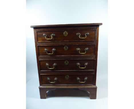 A Miniature Mahogany Chest of Four Drawers with Brass Drop Handles and Bracket Feet, 53 x 35 x 64 Cm High