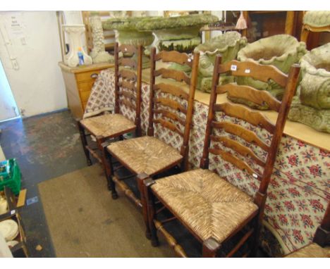 Eight ladder back chairs, (six plus 2 carvers) with rush seats