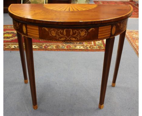 An Edwardian Neo-Classical style mahogany demilune card table, in the manner of Robert Adam, the top with shell inlaid decora