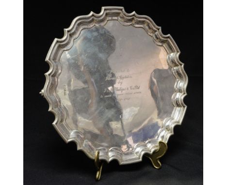 A George V sterling silver salver, in the George II style with Chippendale style border consisting of shallow curved semi-ova