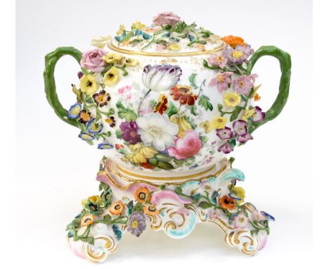 A Dresden porcelain florally encrusted tureen, of twin handled ovoid form on stand, heavily decorated in relief with applied 