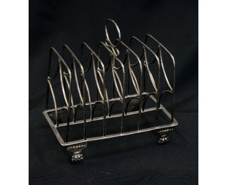 A George III silver six bar toast rack, of rectangular form, standing on four angular fluted lion paw type bracket supports, 