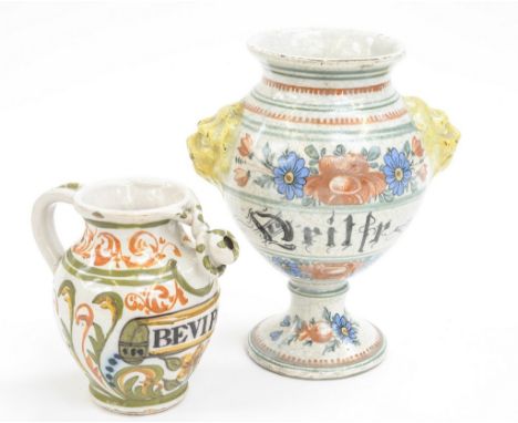 An 18th century maiolica faience pharmacy jar, pedestal form with floral decoration and lions head moulded handles, inscribed
