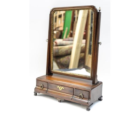 A George II mahogany toilet mirror, the adjustable mirror raised on a base section with three short drawers, standing on brac