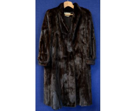 A full length black mink coat, c.1970's, (both sleevves showing some wear and tear)