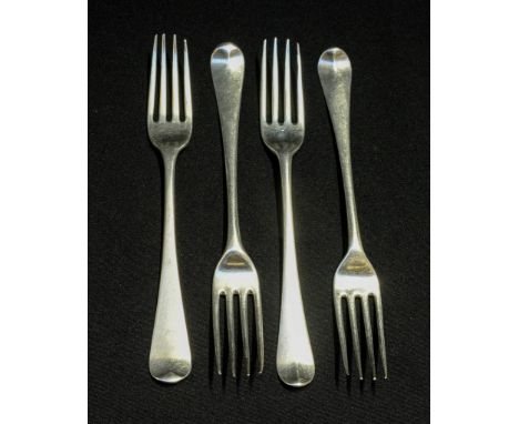 A matched set of four George III sterling silver dinner forks, each with matching period engraved crest to finial verso, vari