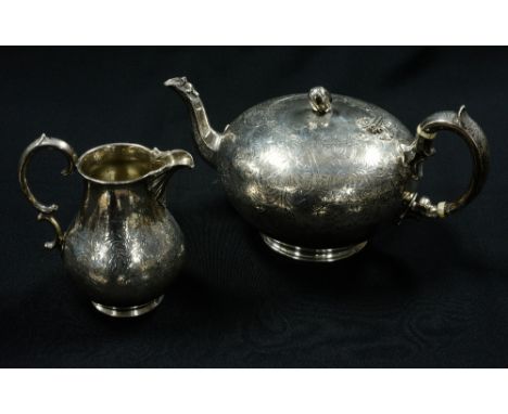 An early Victorian sterling silver teapot and milk jug, teapot of ovoid form, on circular base, flared spout, C scroll handle