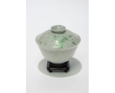 A Chinese carved jade bowl and cover, finely carver, of plain footed form, crushed snow colour with faint green marbling, the