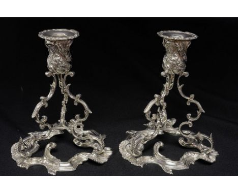 A fine pair of cast Elizabeth II sterling silver candlesticks of exceptional gauge in the rococo style, sconces set atop a su
