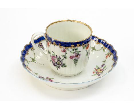 A Worcester coffee cup and saucer, circa 1770, probably decorated by James Giles with floral garlands and sprays, bordered in
