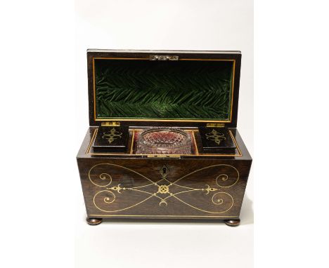 An early 19th century rosewood tea caddy, circa 1830, sarcophagus form, inlaid with brass stringing and black enamel in the E