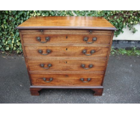 A George III mahogany chest of drawers, circa 1770, comprising brushing slide over four long graduated drawers, all with cock