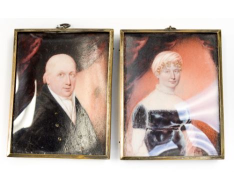 A pair of portrait miniatures on ivory, mid 19th century, gentleman and his wife in front of red drapery, unsigned, later fra