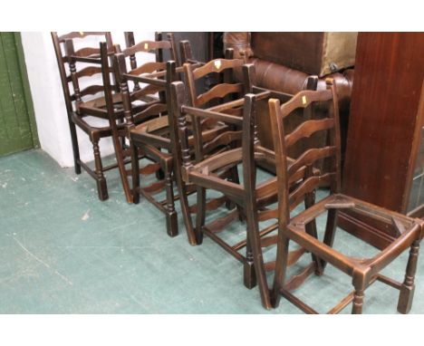 Seven oak ladder back chairs without seat pads