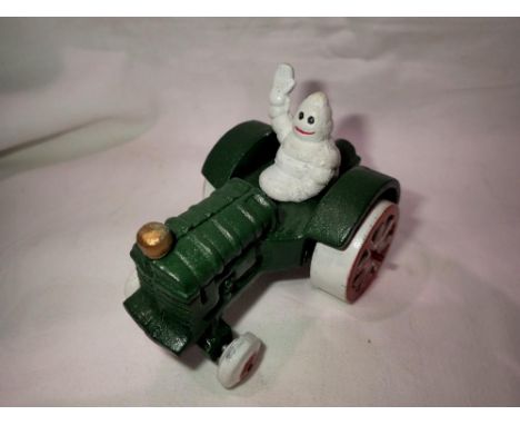Cast iron Michellin Man on a tractor. H:80mm. UK P&amp;P Group 1 (£16+VAT for the first lot and £2+VAT for subsequent lots) 