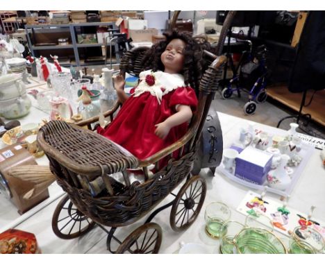 Ceramic doll in wicker pram. Not available for in-house P&amp;P 