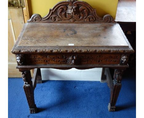 *Item to be collected from Friargate, Derby*A Victorian oak side table, the galleried back carved with mask and foliage, the 