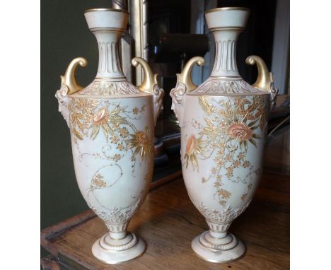 *Item to be collected from Friargate, Derby* A pair of Royal Worcester blush ivory pedestal urnular vases, masked twin handle