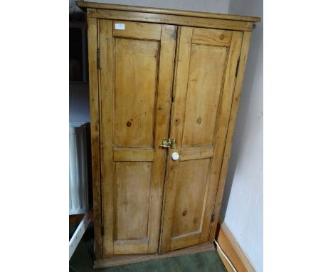 *Item to be collected from Friargate, Derby*A Victorian pine housekeeper's cupboard, two long doors opening to reveal three f