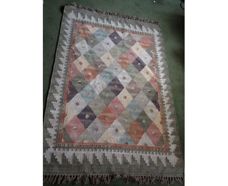 *Item to be collected from Friargate, Derby*A woollen rug in tones of green, blue, orange, pink etc, approx 180cm x 122cm; to