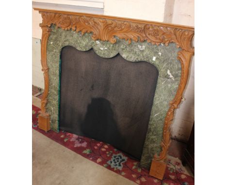 A carved pinewood mantelpiece with fitted slips and fabric backing 118cm high, 134cm wide 