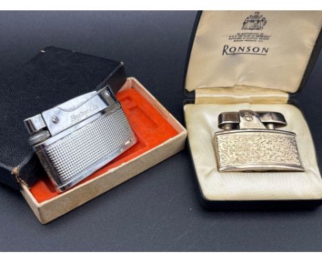 A boxed Ronson petrol lighter and another example