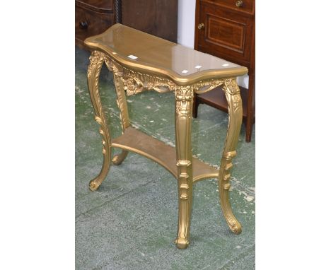 A 20th century ornate gilt console table, decorated with flowers and leafy scrolls