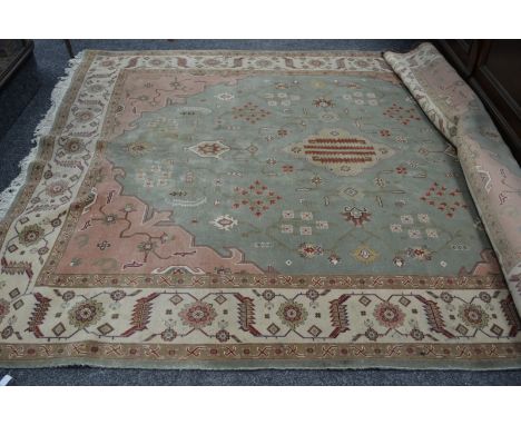 An Heriz Iranian woolen carpet, geometric and floral designs. 296cm x 241cm