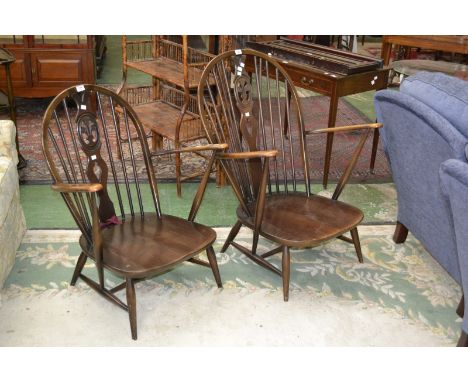 An Ercol gents and ladies open arm chairs with  pierced splat back and turned spindles 