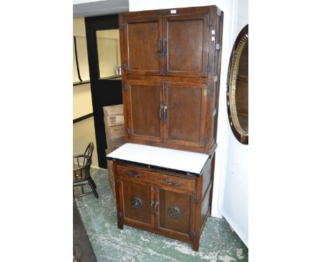 An mid 20th century Hygena oak kitchen cabinet with enamel top