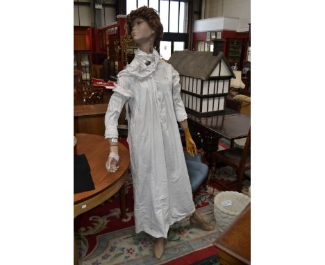 A vintage lady mannequin with dresses