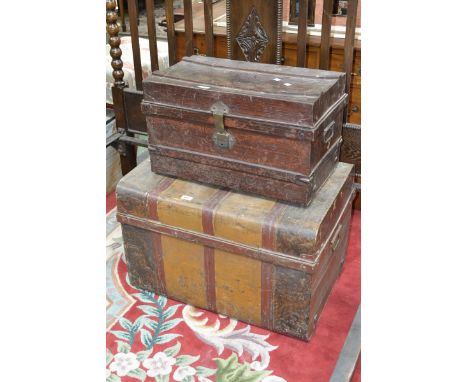 Two vintage tin travel trunks.