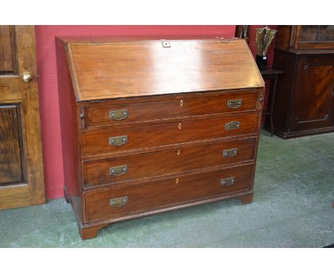 A George III mahogany bureau, the fall front enclosing an arrangement of pigeon holes and drawers, four long graduated cock b