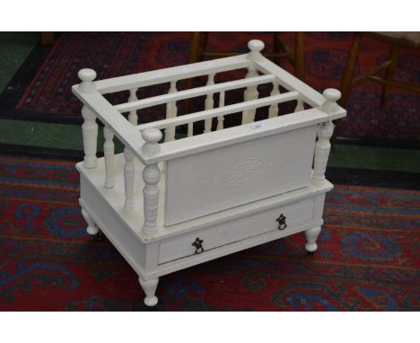 A 20th century painted three division canterbury, turned finial, spindled divisions, drawer to base, turned supports, ceramic