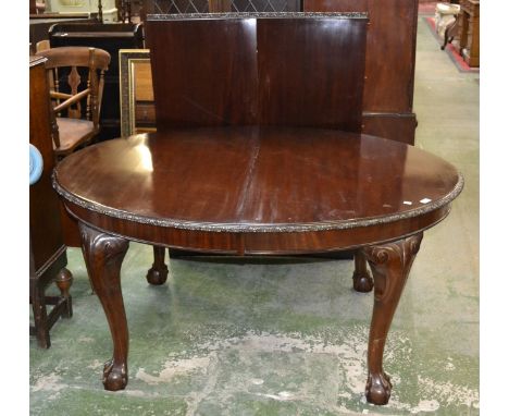 A Chippendale Revival mahogany wind-out dining table, two additional leaves, ball and claw feet, c.1920