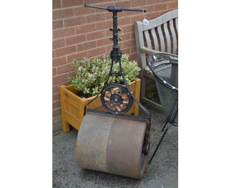 A cast iron garden roller.