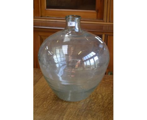 A vintage globular carboy with inclusions.