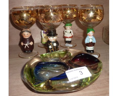 5 drinking glasses with Hummel style figurines on the stems and a glass ash tray