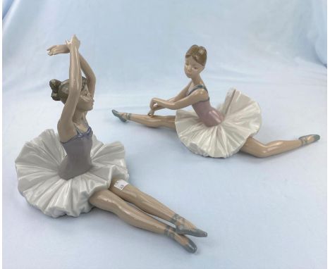 Two large Nao figures of girl ballerinas doing floor exercises 