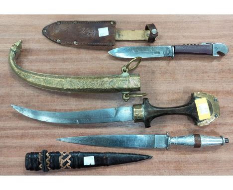 A vintage Middle Eastern curved blade dagger with ornate brass scabbard &amp; other sheathed knives. 