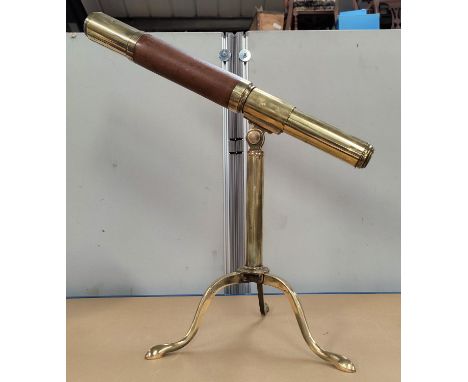 A reproduction brass table top telescope on tripod base 