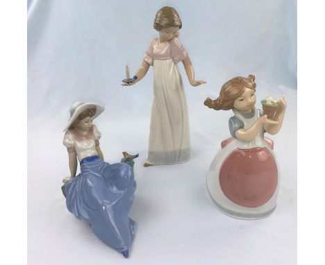 Three Nao figures - girl with candle, girl with pot of flowers, reclining girl with bird 