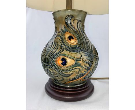 A Moorcroft baluster table lamp decorated with peacock feathers with shade height of base 19cm