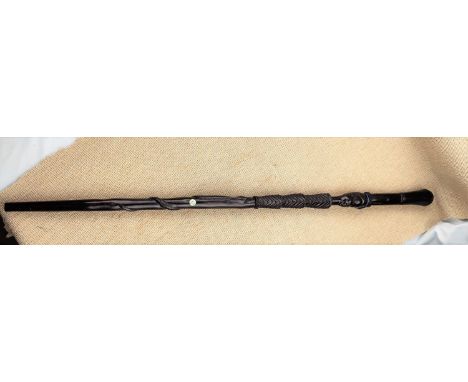An African carved hardwood walking stick with carved face and snake, 90cm 
