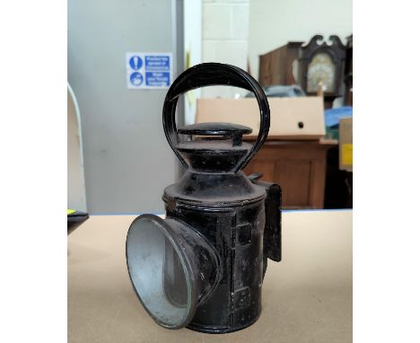 A LMS black japanned metal railway lamp with red and green facetted lenses, oval brass plate L.M.S. 53364, 29cm