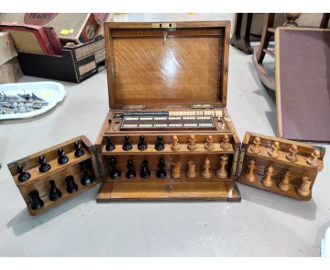 A late 19th/early 20th century oak games compendium including chess, drafts, cribbage etc in filled box 