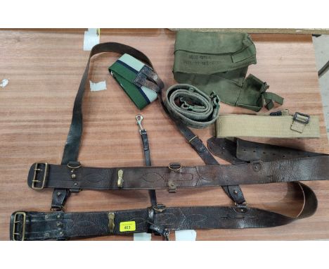 Two WWI style military leather bets one with sash attached and a selection of military canvas belts 