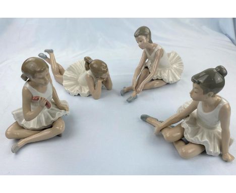 Four Nao figures of girl ballerinas doing floor exercises 