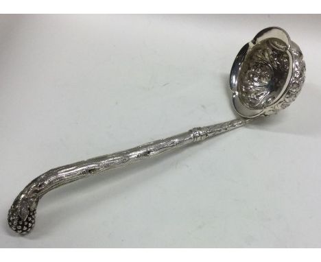 EDINBURGH: A rare cast Scottish silver ladle embossed with scrolls and bark decoration. Approx. 74 grams. Est. £200 - £300.