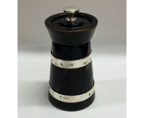 A silver mounted and ebony pepper grinder of tapering form. Birmingham. Approx. 138 grams. Est. £30 - £50.
